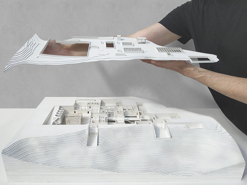 Estudiante propone esculpir baños en el paisaje volcánico de una isla griega