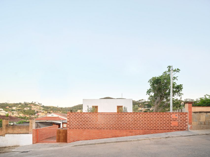 Agora Arquitectura eleva casa prefabricada de madera sobre base de ladrillo